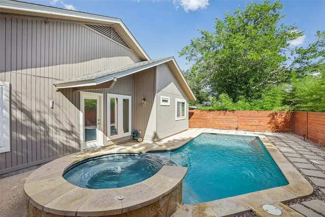 a view of backyard with swimming pool