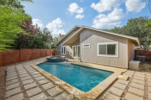 a backyard of a house with table and chairs