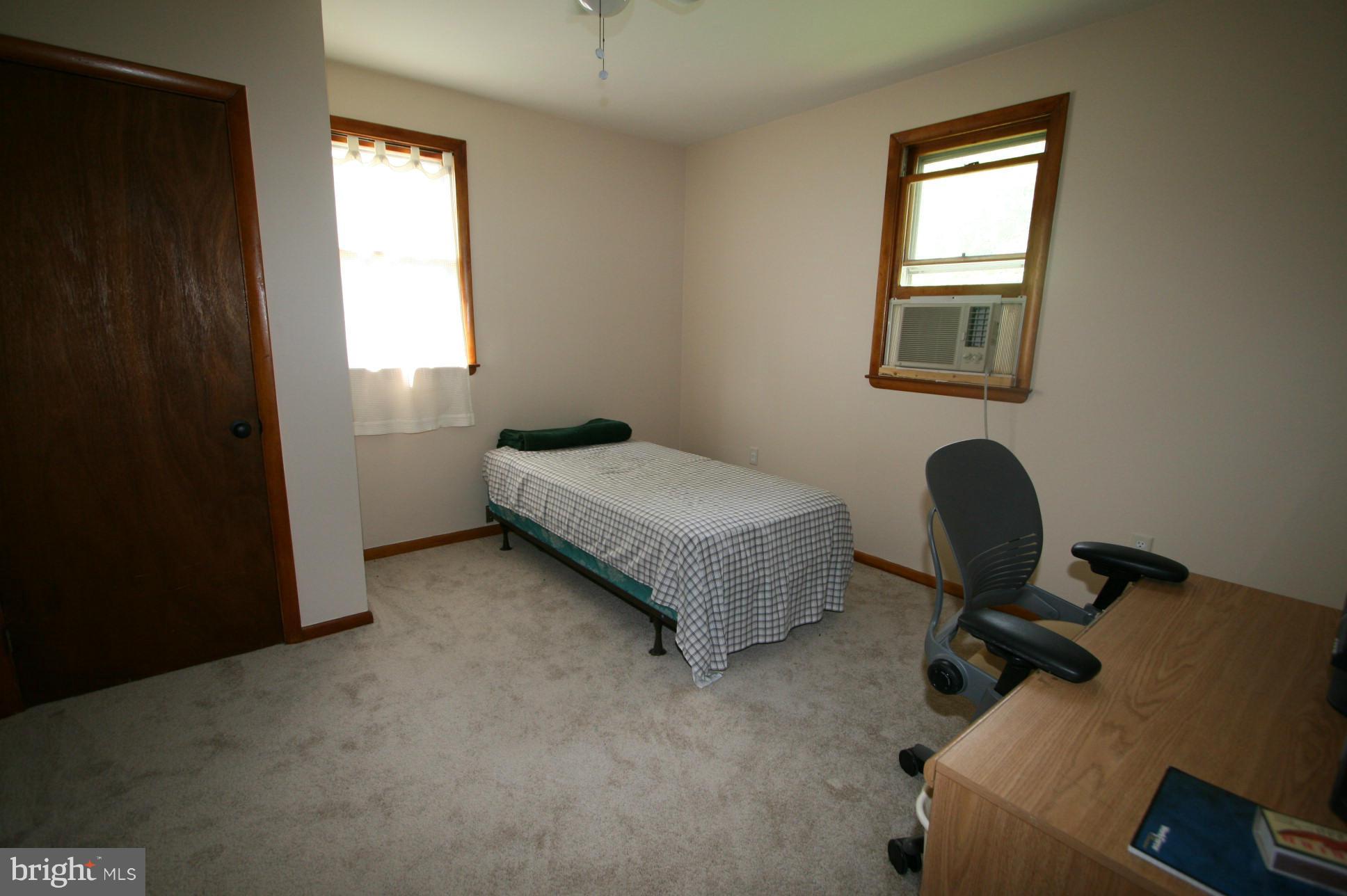 500 Cleveland Road Linthicum Heights, MD 21090 - Photo 11 of 26 a bedroom with a bed windows and chair