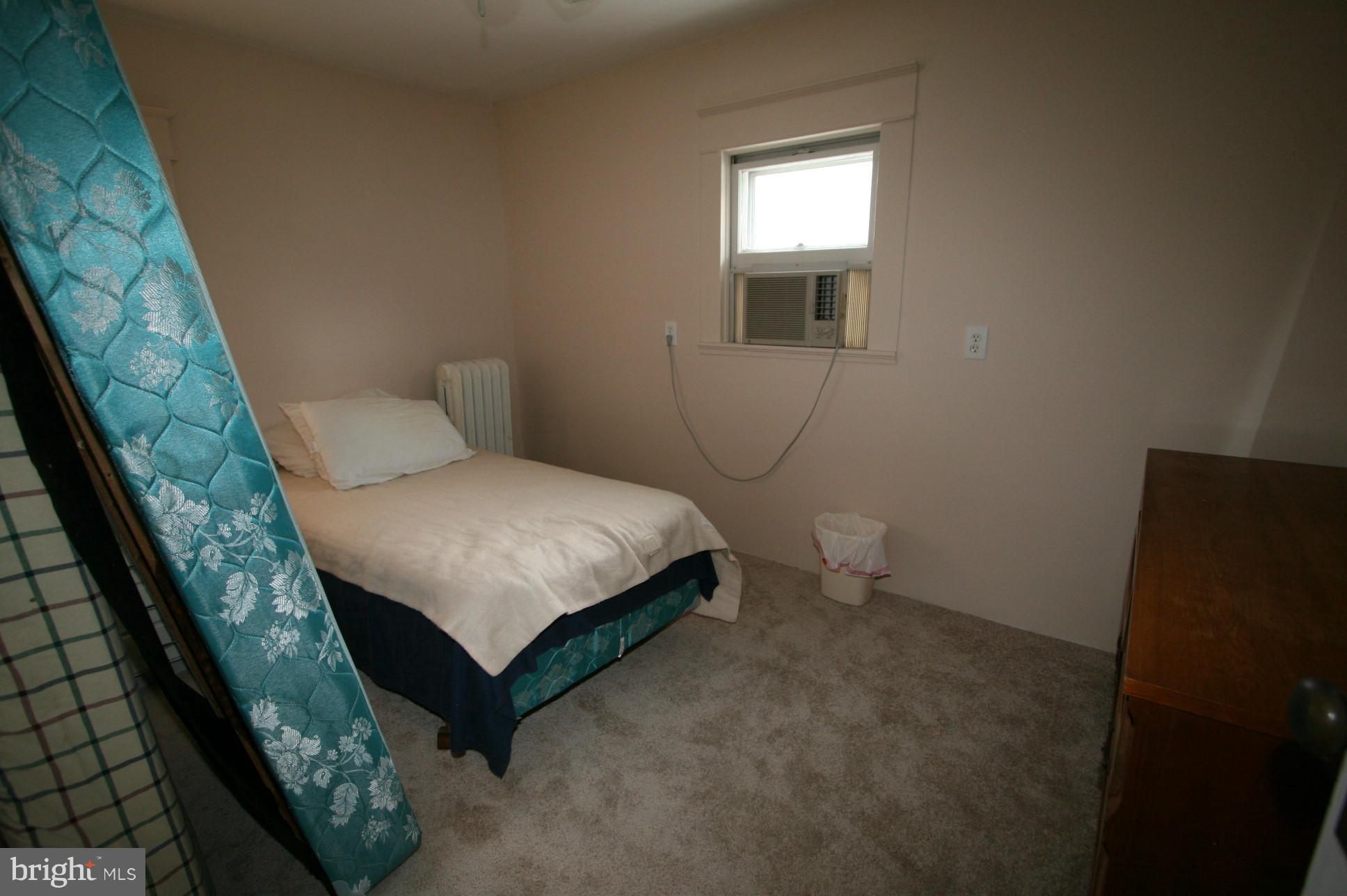 500 Cleveland Road Linthicum Heights, MD 21090 - Photo 15 of 26 a bed sitting in a bedroom next to a window