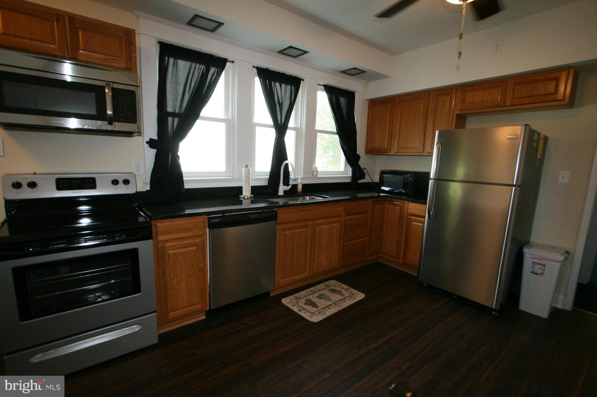 500 Cleveland Road Linthicum Heights, MD 21090 - Photo 6 of 26 a kitchen with sink a window and stainless steel appliances