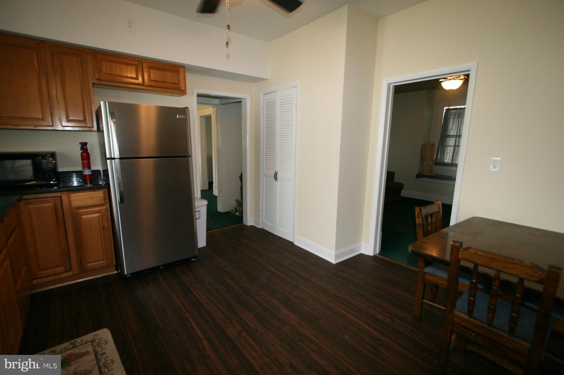 500 Cleveland Road Linthicum Heights, MD 21090 - Photo 9 of 26 a kitchen with a refrigerator and a stove top oven