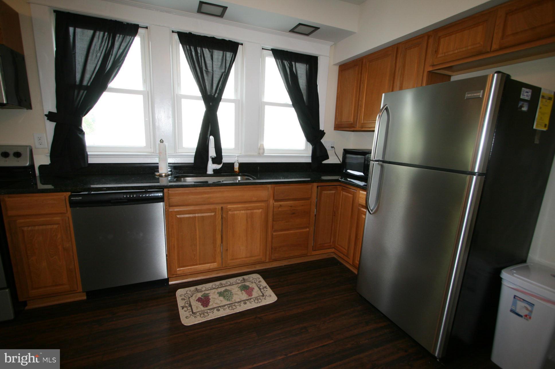 500 Cleveland Road Linthicum Heights, MD 21090 - Photo 10 of 26 a kitchen with stainless steel appliances a refrigerator a sink a window and cabinets