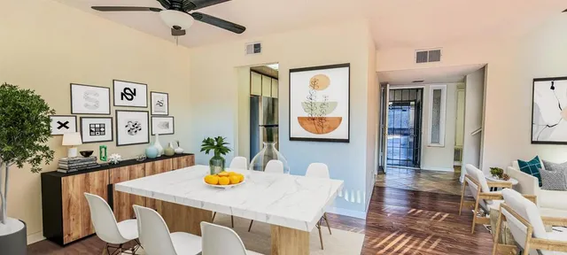 a view of a dining room with furniture and a potted plant
