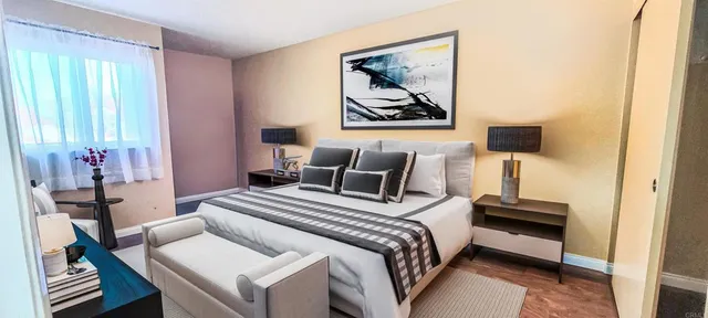 a bedroom with a bed and a flat screen tv