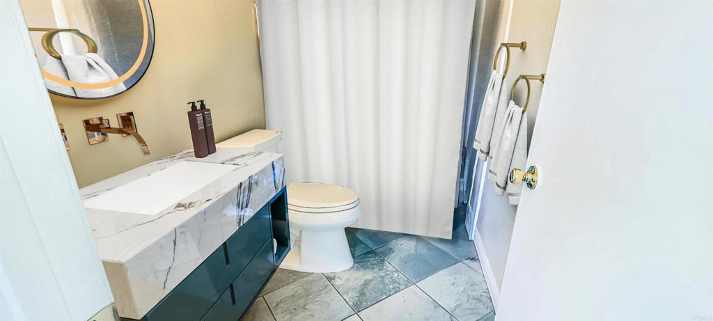 1469 Sundance Way Oceanside, CA 92057 - Photo 15 of 27 a white toilet sitting next to a bathroom sink