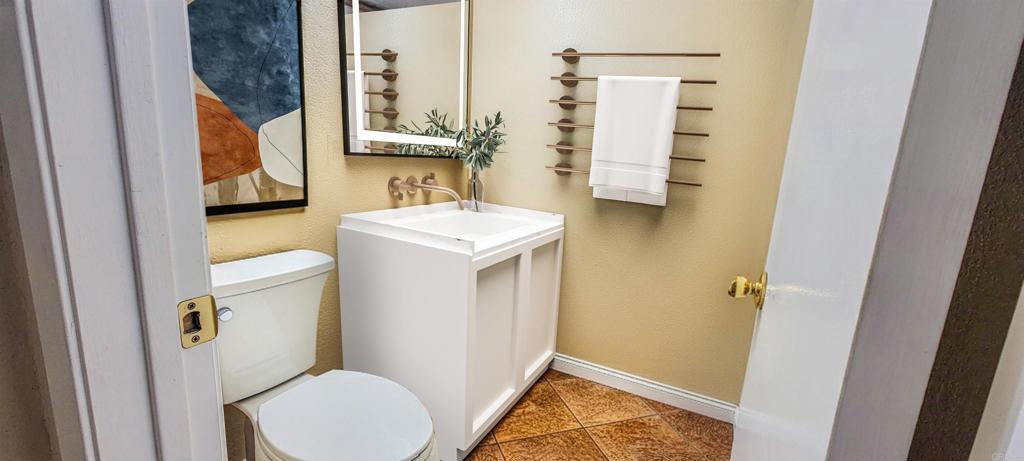 1469 Sundance Way Oceanside, CA 92057 - Photo 2 of 27 a bathroom with a sink toilet and mirror