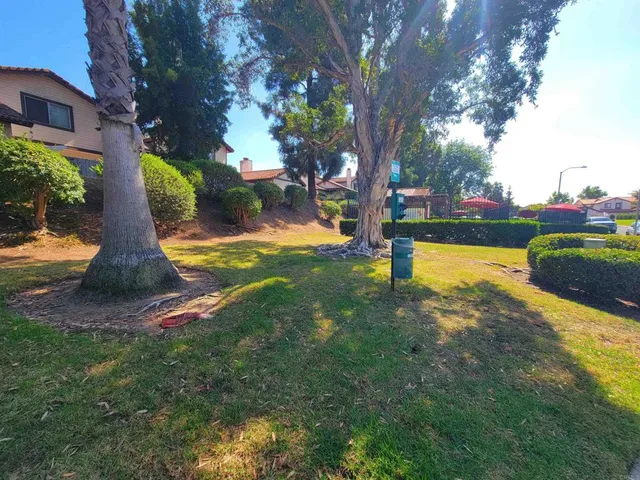 a view of a fountain in front of house with a yard