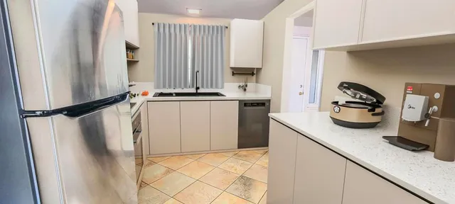 a kitchen with a sink and a refrigerator