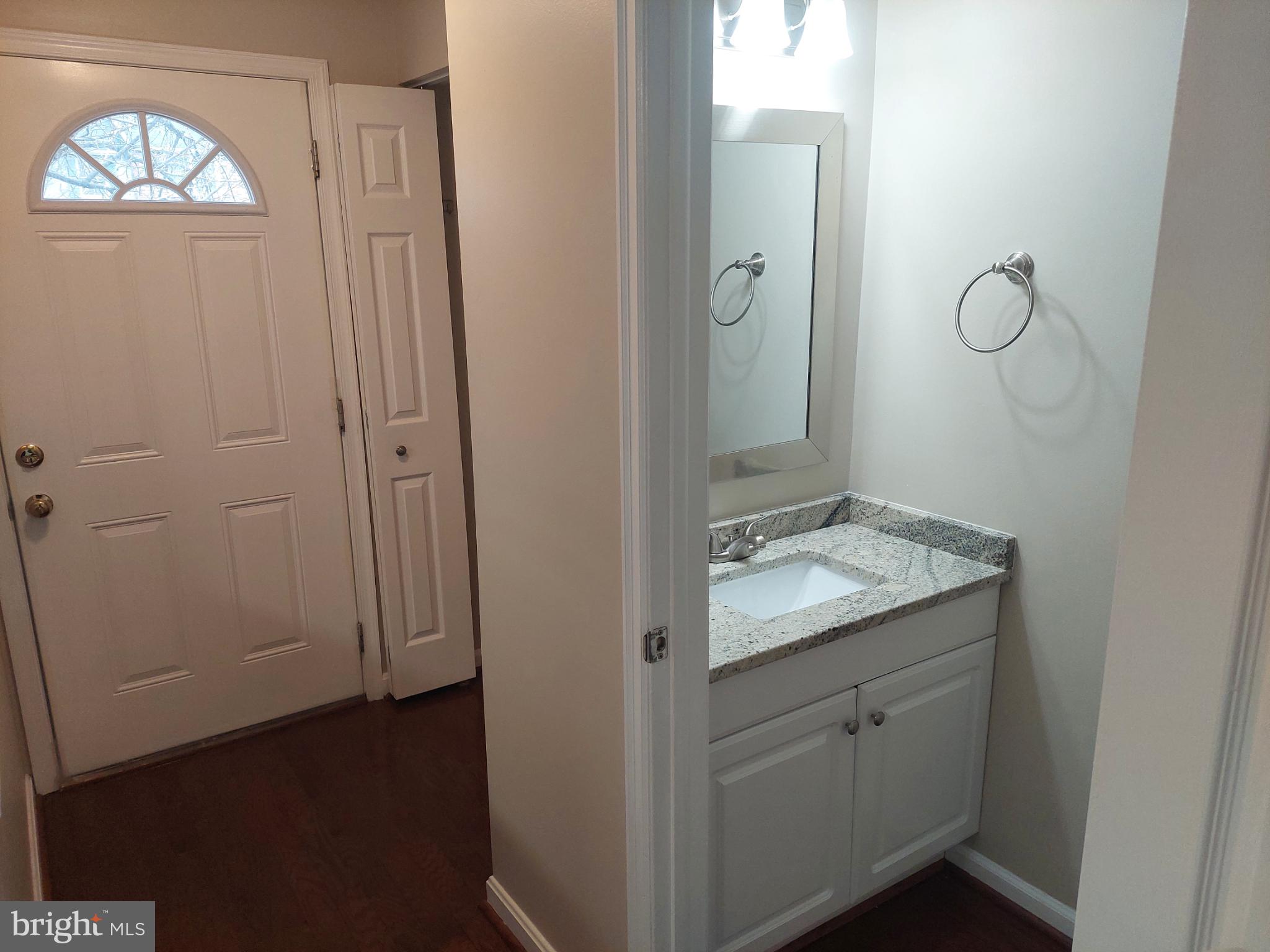 10149 Shelldrake Circle Damascus, MD 20872 - Photo 19 of 73 a bathroom with a granite countertop sink a mirror and a vanity
