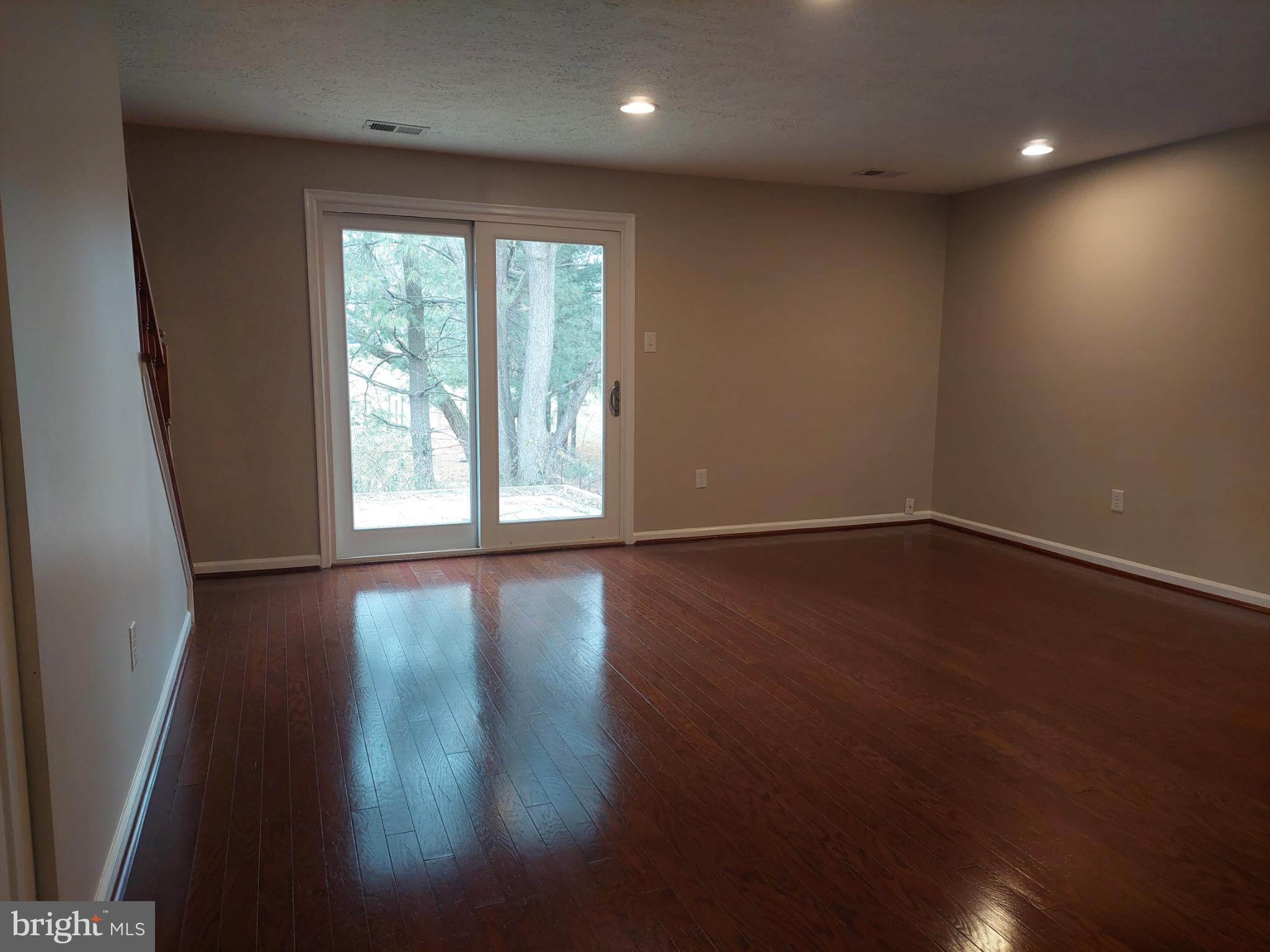 10149 Shelldrake Circle Damascus, MD 20872 - Photo 22 of 73 a view of an empty room with wooden floor and a window