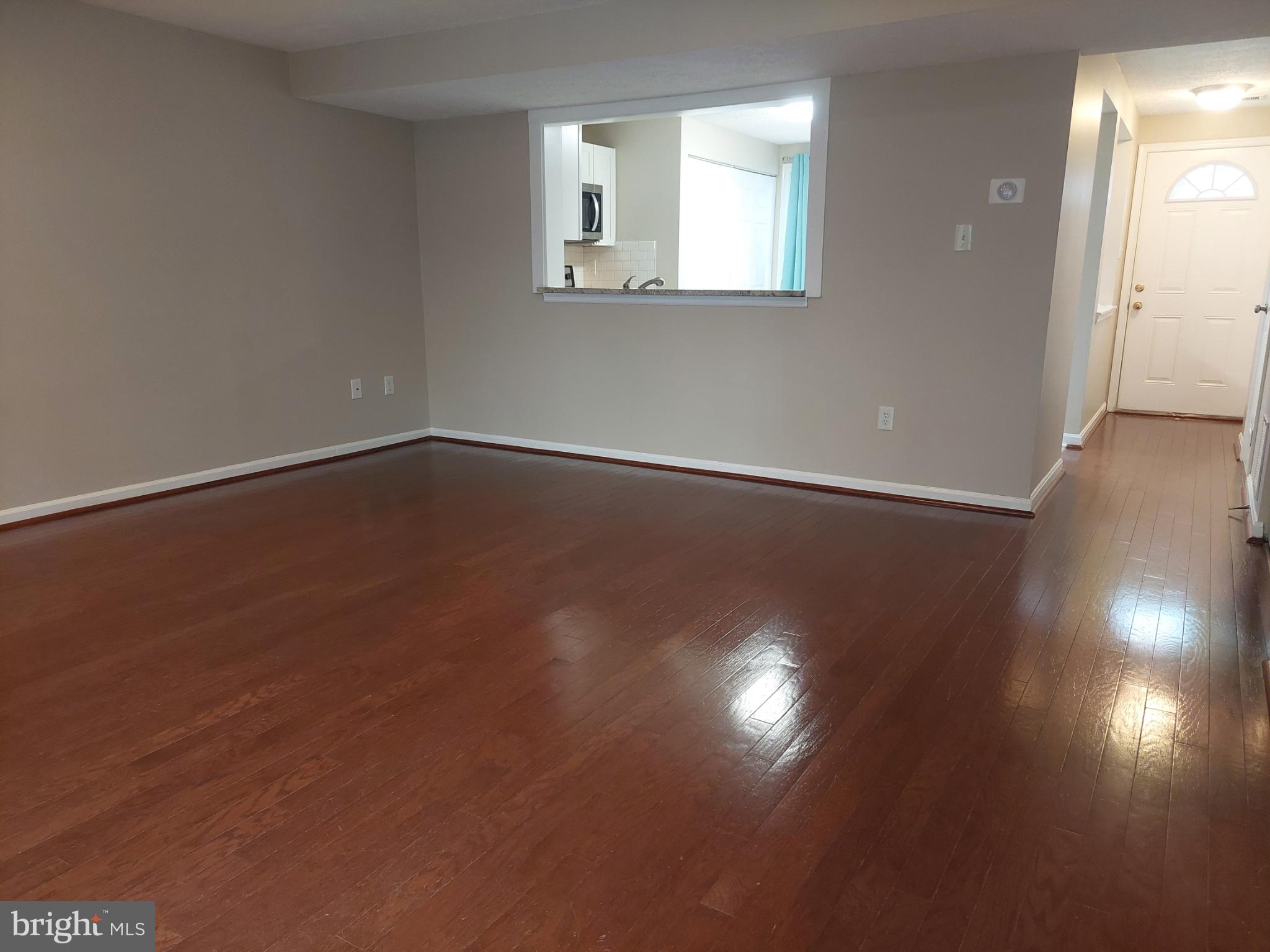 10149 Shelldrake Circle Damascus, MD 20872 - Photo 23 of 73 an empty room with wooden floor and windows