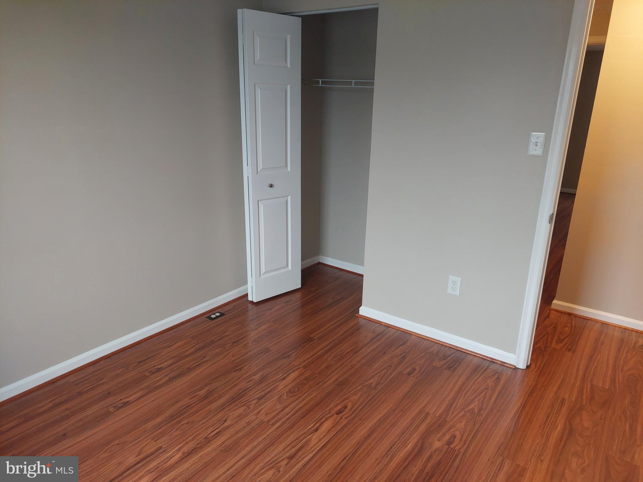 10149 Shelldrake Circle Damascus, MD 20872 - Photo 41 of 73 a view of an empty room with wooden floor and a window