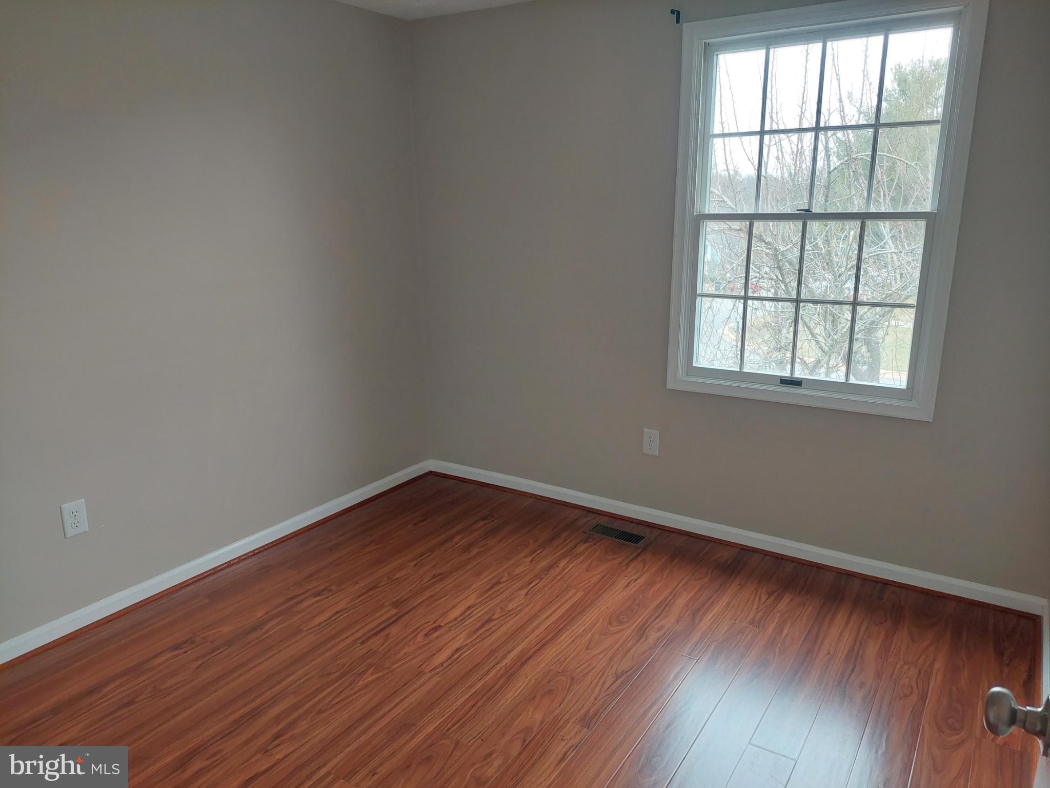 10149 Shelldrake Circle Damascus, MD 20872 - Photo 45 of 73 an empty room with wooden floor and windows