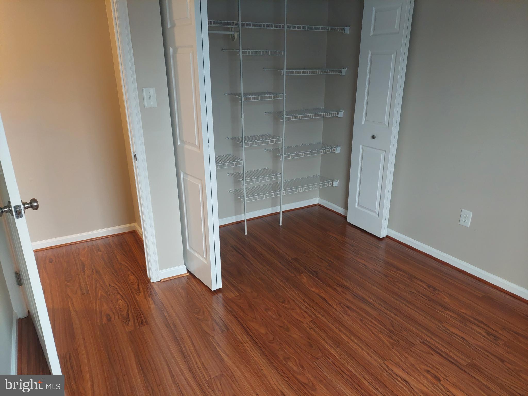 10149 Shelldrake Circle Damascus, MD 20872 - Photo 49 of 73 an empty room with wooden floor and entrance
