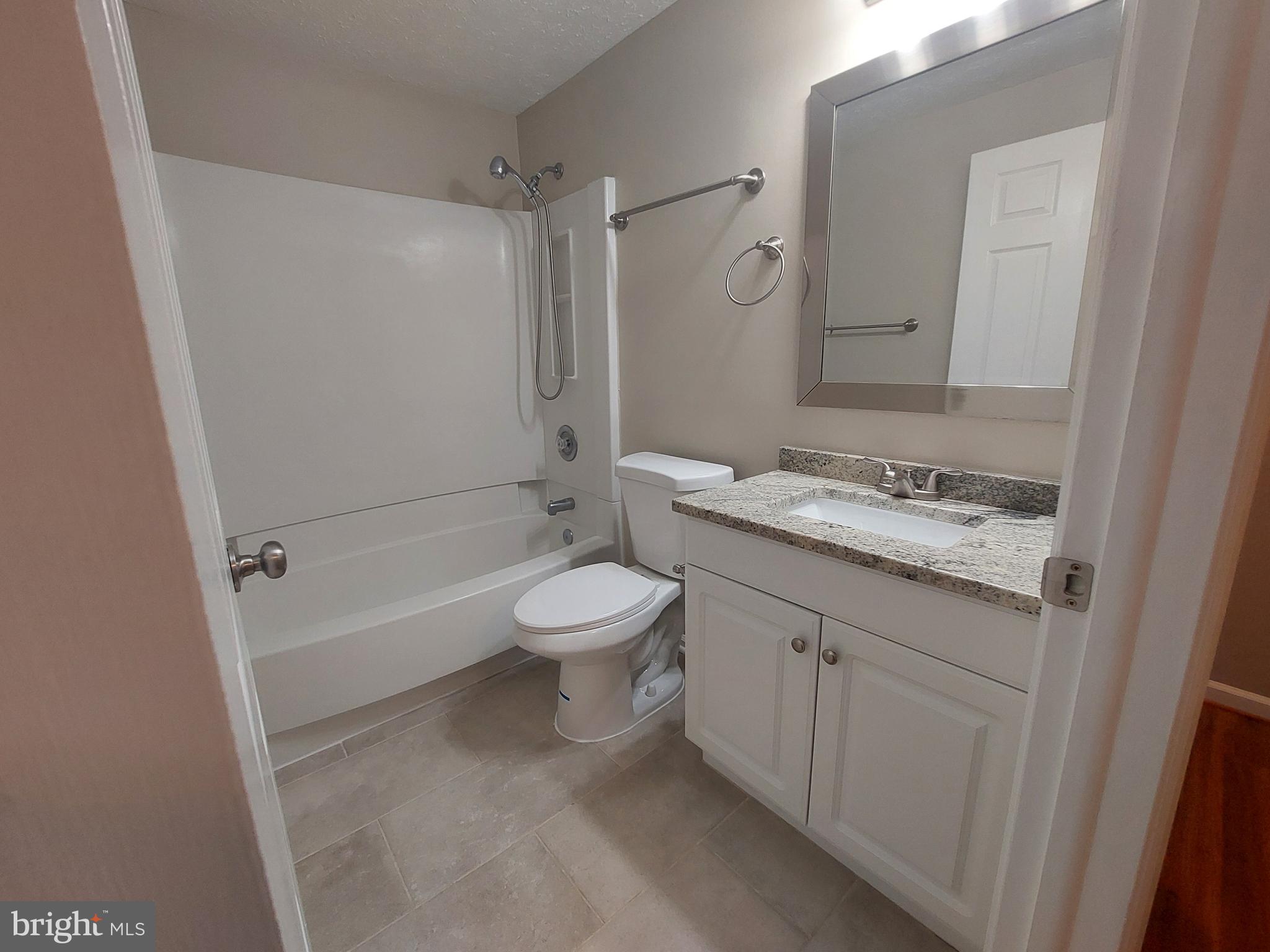 10149 Shelldrake Circle Damascus, MD 20872 - Photo 51 of 73 a bathroom with a granite countertop sink toilet and shower