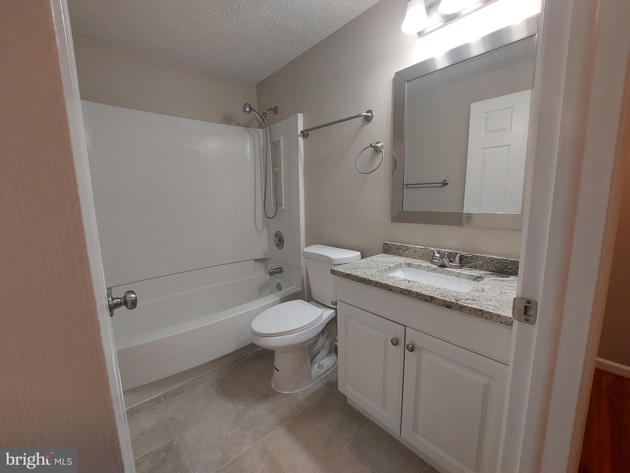 10149 Shelldrake Circle Damascus, MD 20872 - Photo 52 of 73 a bathroom with a granite countertop sink toilet and shower