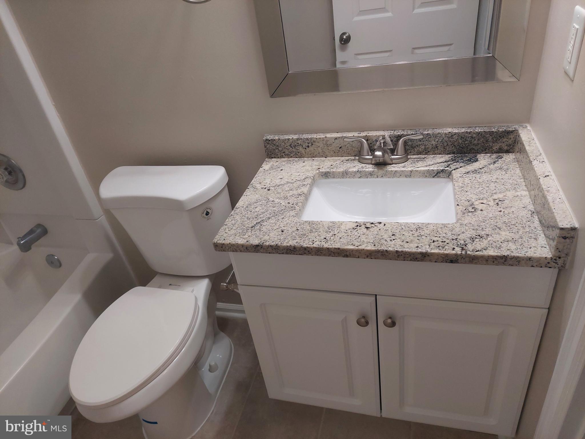 10149 Shelldrake Circle Damascus, MD 20872 - Photo 56 of 73 a bathroom with a granite countertop toilet sink and mirror