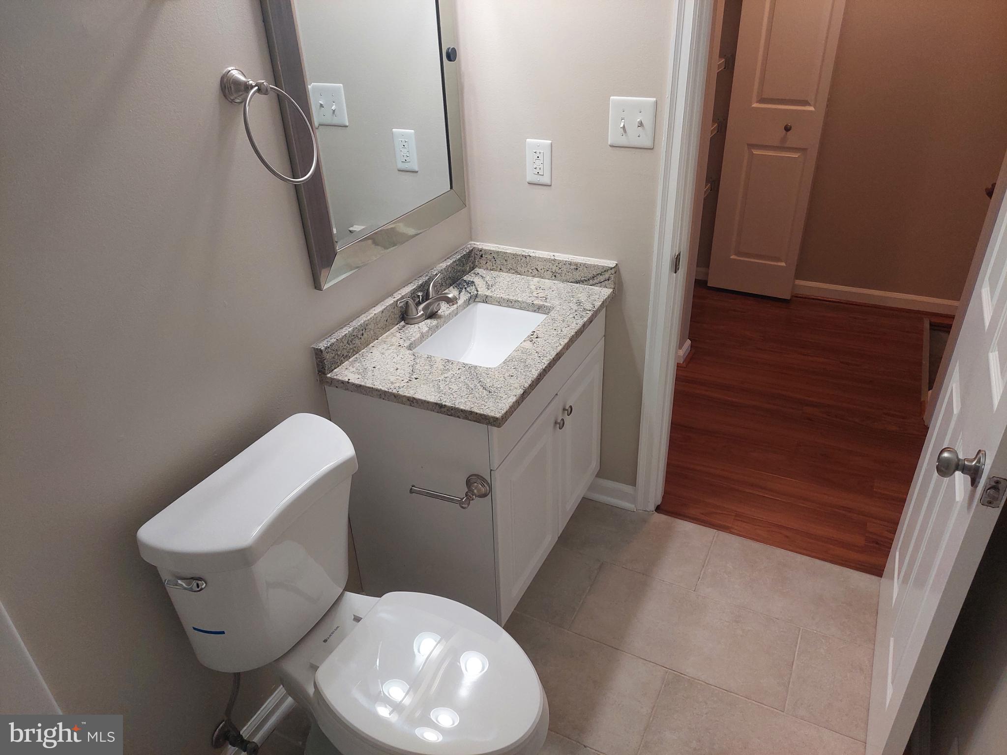 10149 Shelldrake Circle Damascus, MD 20872 - Photo 57 of 73 a bathroom with a toilet sink and mirror