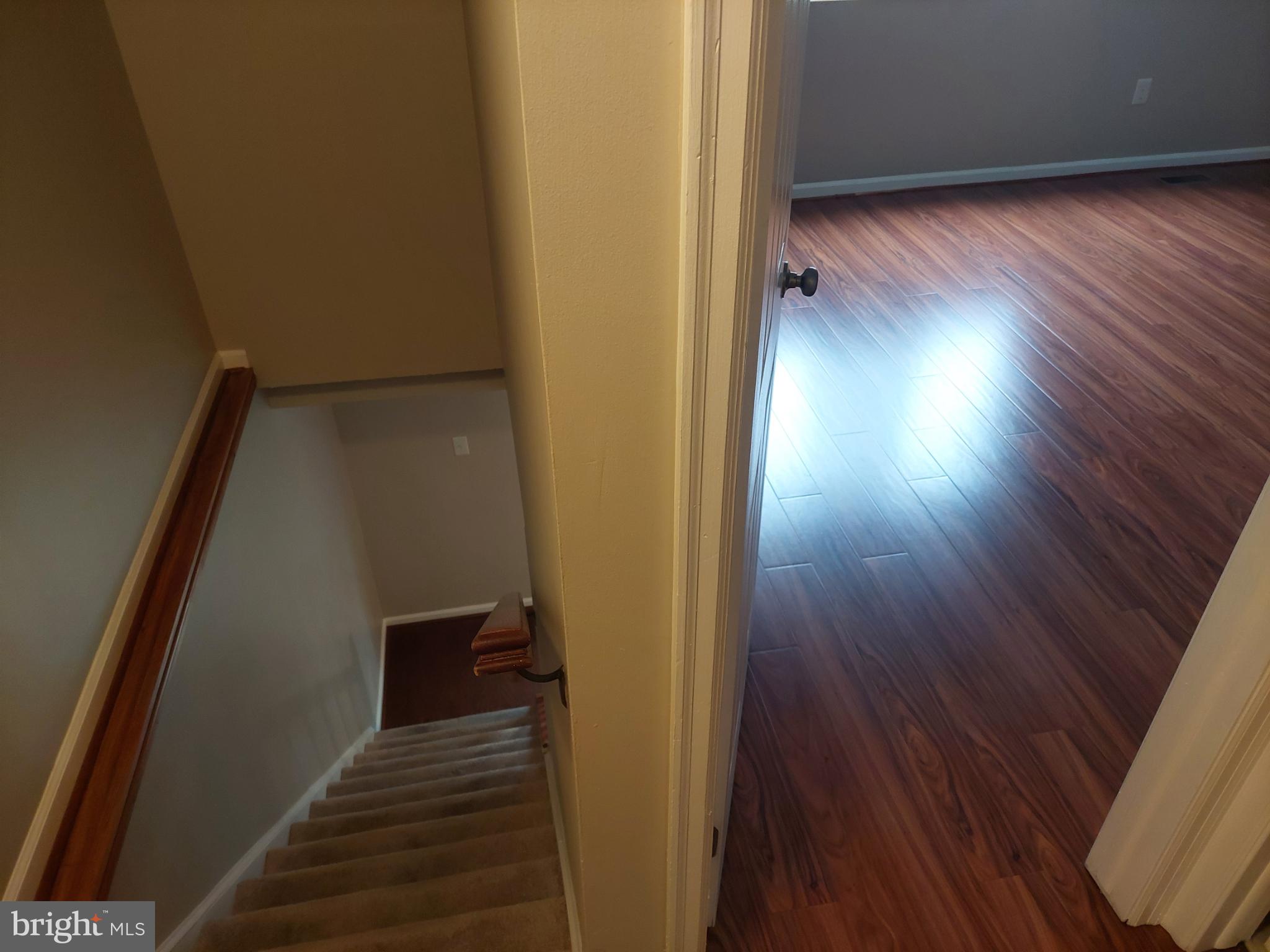 10149 Shelldrake Circle Damascus, MD 20872 - Photo 58 of 73 a view of a hallway with wooden floor and staircase