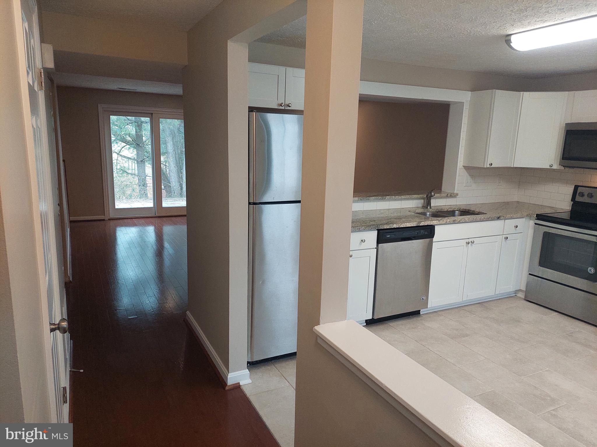 10149 Shelldrake Circle Damascus, MD 20872 - Photo 6 of 73 a kitchen with stainless steel appliances granite countertop a refrigerator a sink a stove a microwave oven with cabinets