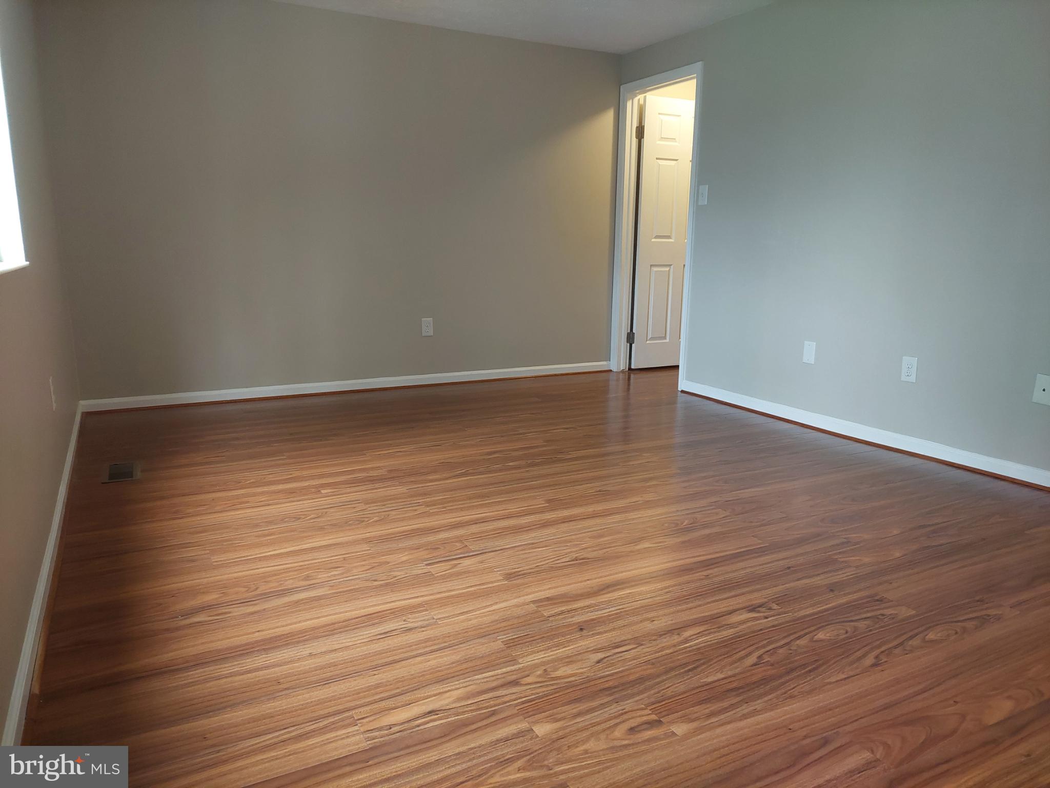 10149 Shelldrake Circle Damascus, MD 20872 - Photo 61 of 73 a view of an empty room with wooden floor and a window