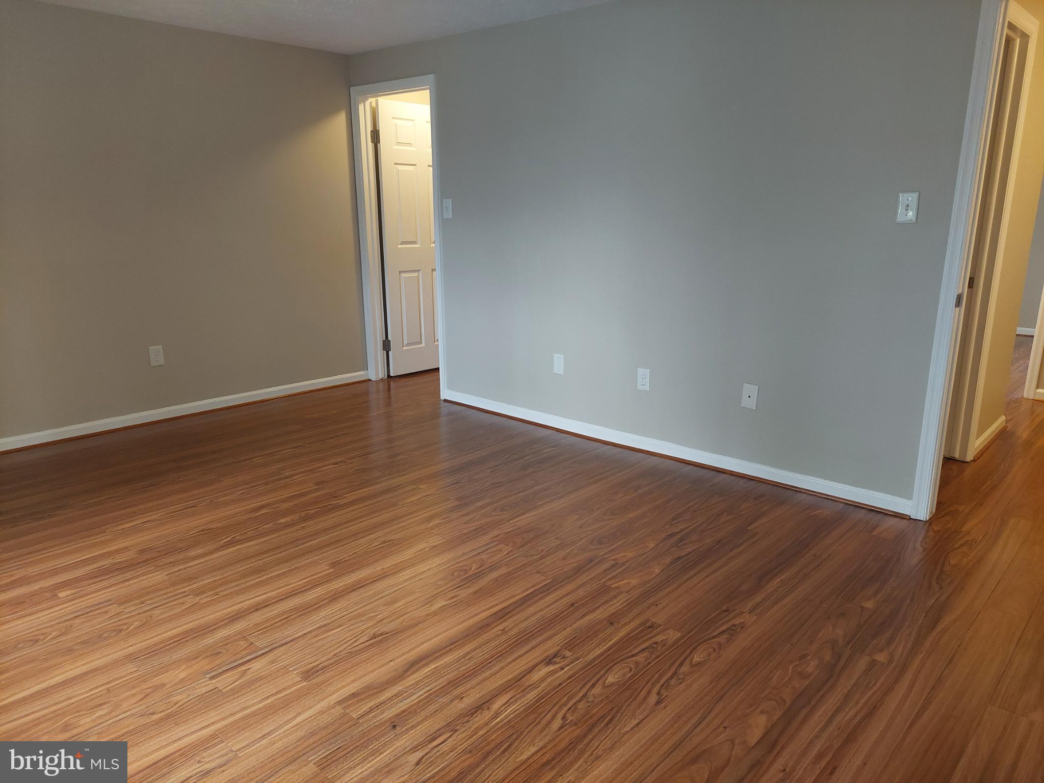 10149 Shelldrake Circle Damascus, MD 20872 - Photo 62 of 73 a view of an empty room with wooden floor and a window
