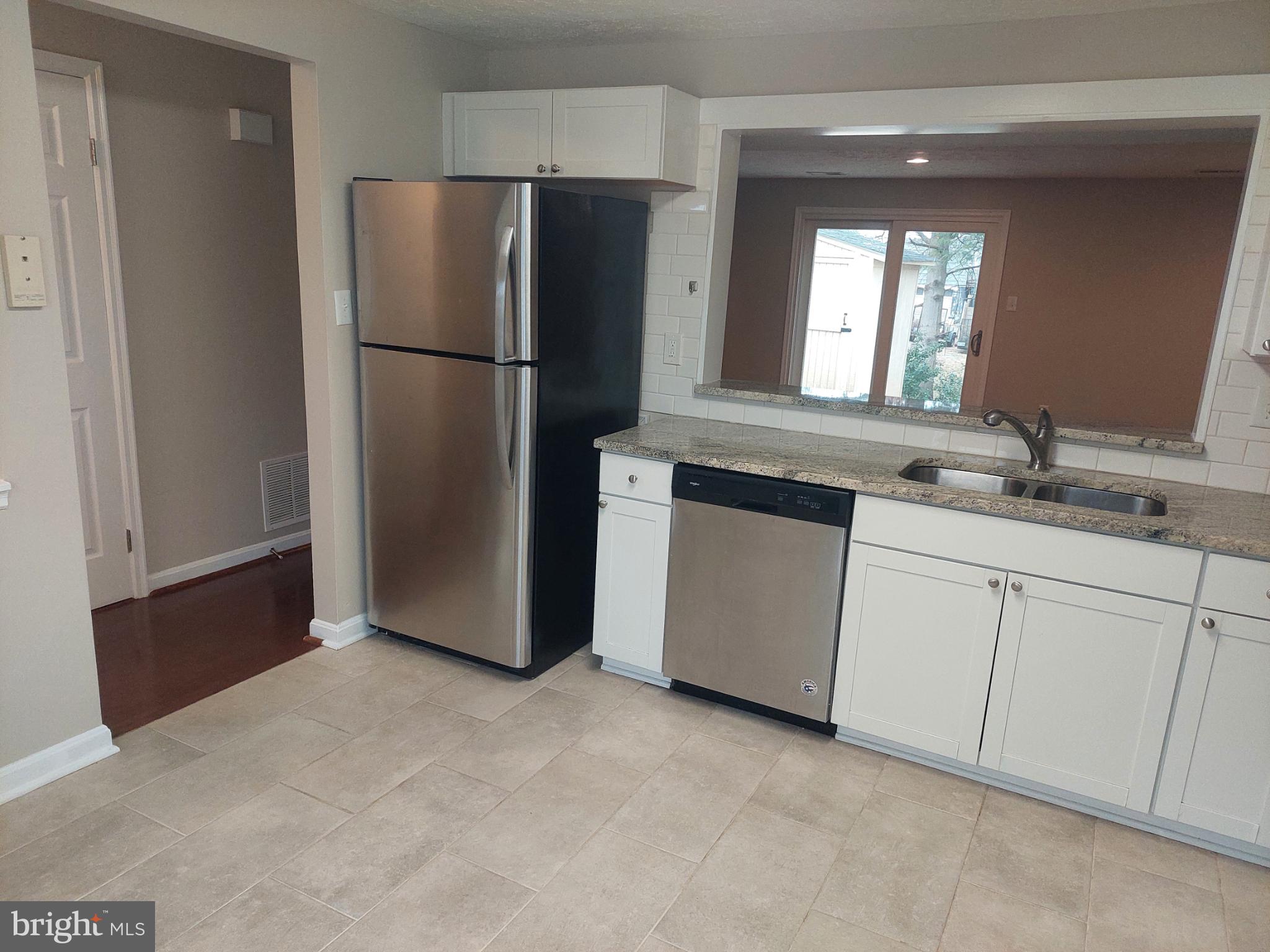 10149 Shelldrake Circle Damascus, MD 20872 - Photo 8 of 73 a kitchen with stainless steel appliances granite countertop a refrigerator a sink and white cabinets