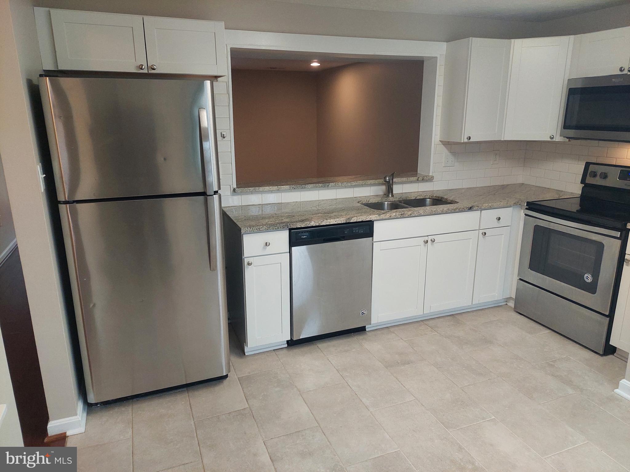 10149 Shelldrake Circle Damascus, MD 20872 - Photo 9 of 73 a kitchen with stainless steel appliances granite countertop a refrigerator a stove a sink and a granite counter tops