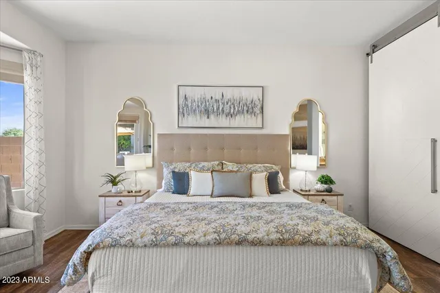 a bedroom with a bed and a painting on the wall