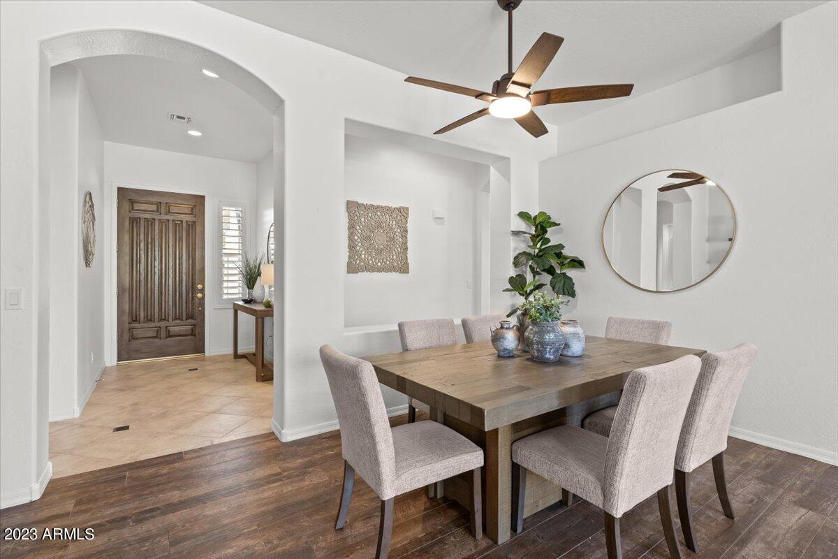 14257 North 106th Place Scottsdale, AZ 85255 - Photo 11 of 58 a dining room with wooden floor a glass table and chairs