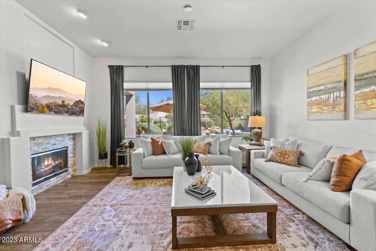 14257 North 106th Place Scottsdale, AZ 85255 - Photo 15 of 58 a living room with furniture large window and a fireplace
