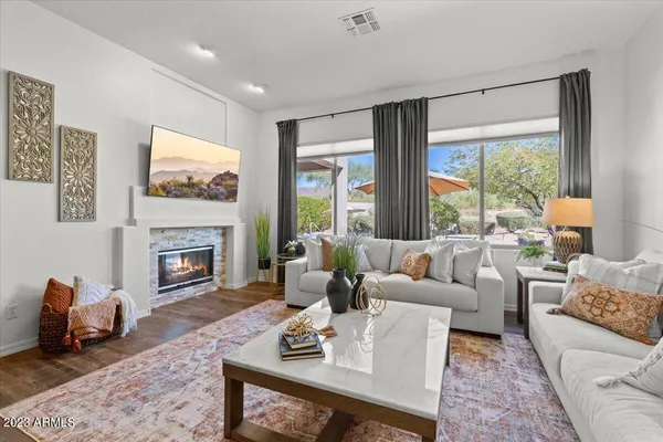 a living room with furniture a dining table and a chandelier