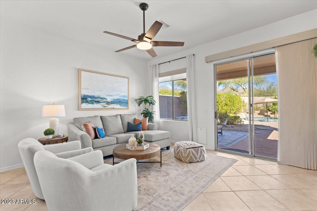 14257 North 106th Place Scottsdale, AZ 85255 - Photo 18 of 58 a living room with furniture and a floor to ceiling window