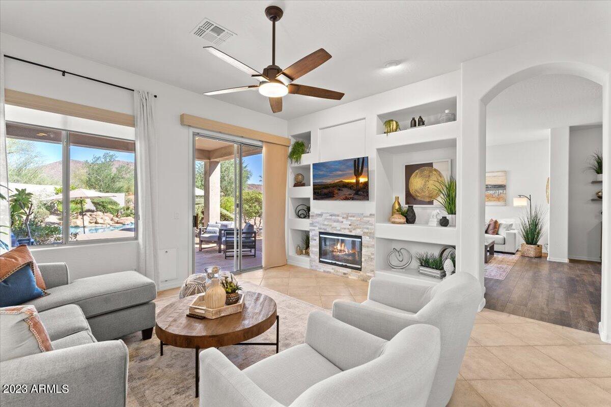 14257 North 106th Place Scottsdale, AZ 85255 - Photo 2 of 58 a living room with fireplace furniture and a large window