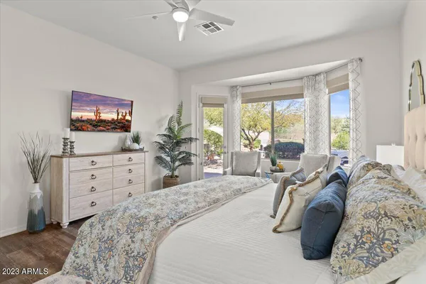 a living room with furniture and a floor to ceiling window