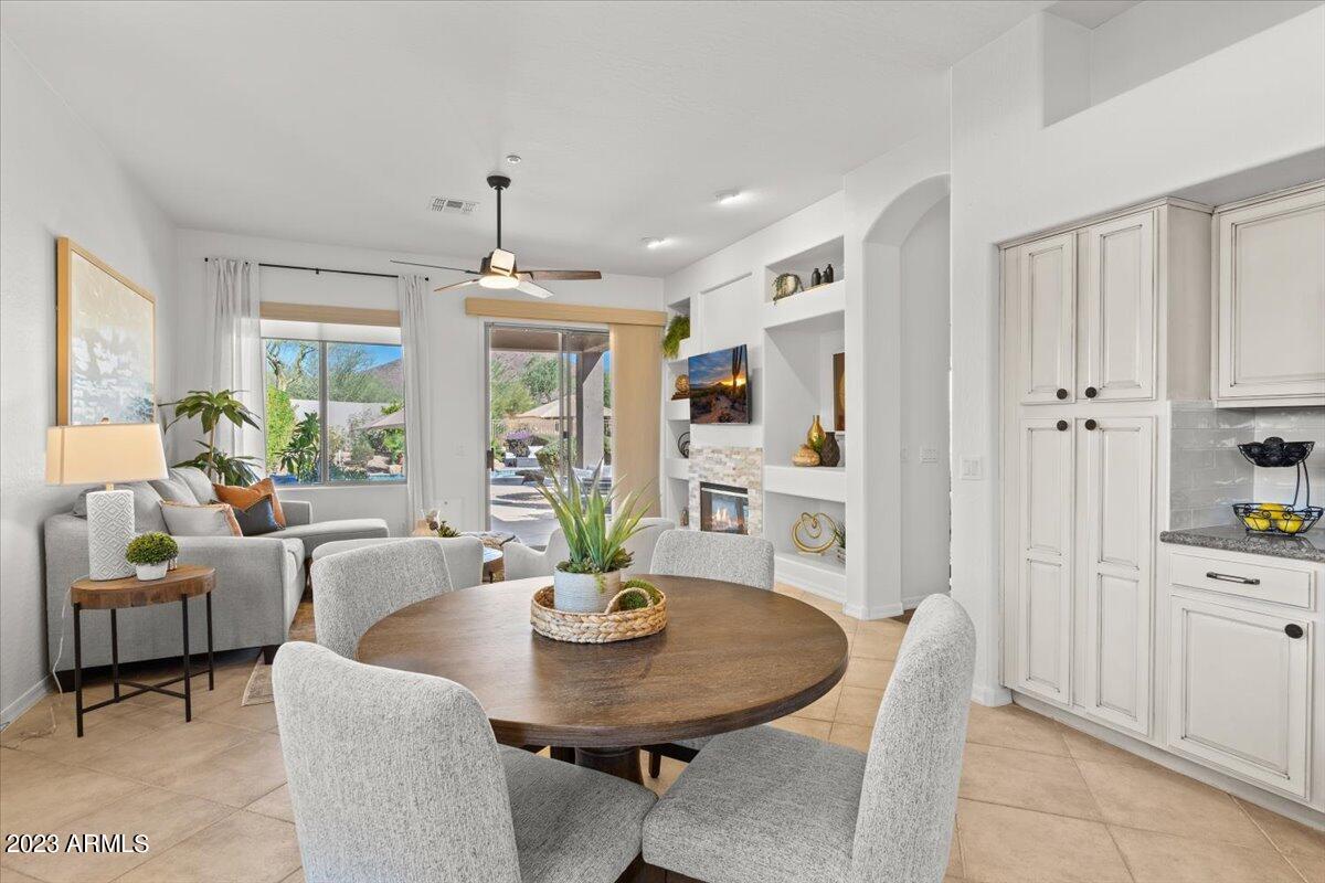 14257 North 106th Place Scottsdale, AZ 85255 - Photo 21 of 58 a living room with furniture a dining table and a chandelier