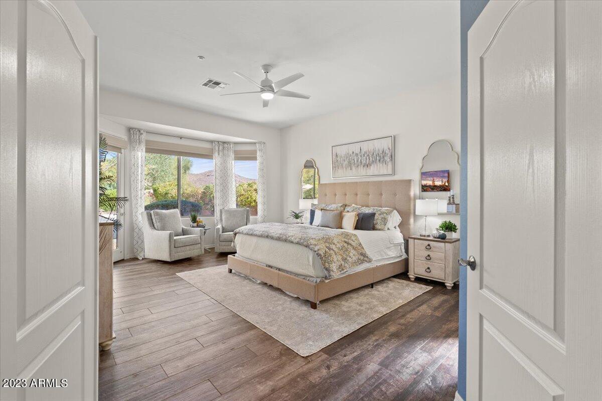 14257 North 106th Place Scottsdale, AZ 85255 - Photo 26 of 58 a bedroom with a bed couch and a window