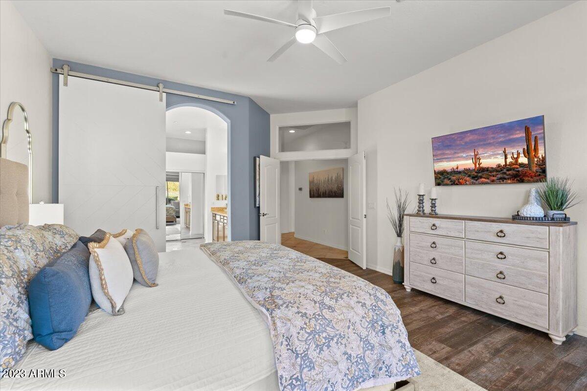 14257 North 106th Place Scottsdale, AZ 85255 - Photo 29 of 58 a bedroom with a bed and a flat screen tv