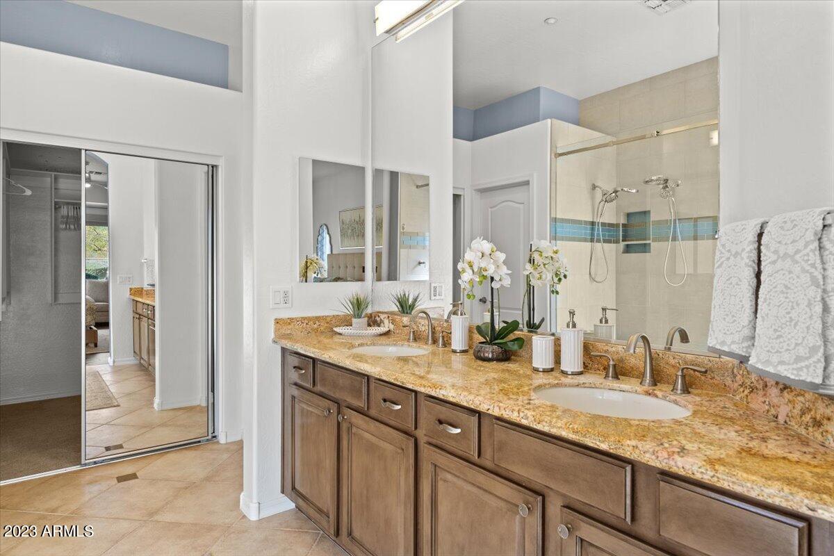 14257 North 106th Place Scottsdale, AZ 85255 - Photo 30 of 58 a bathroom with a granite countertop sink and a mirror