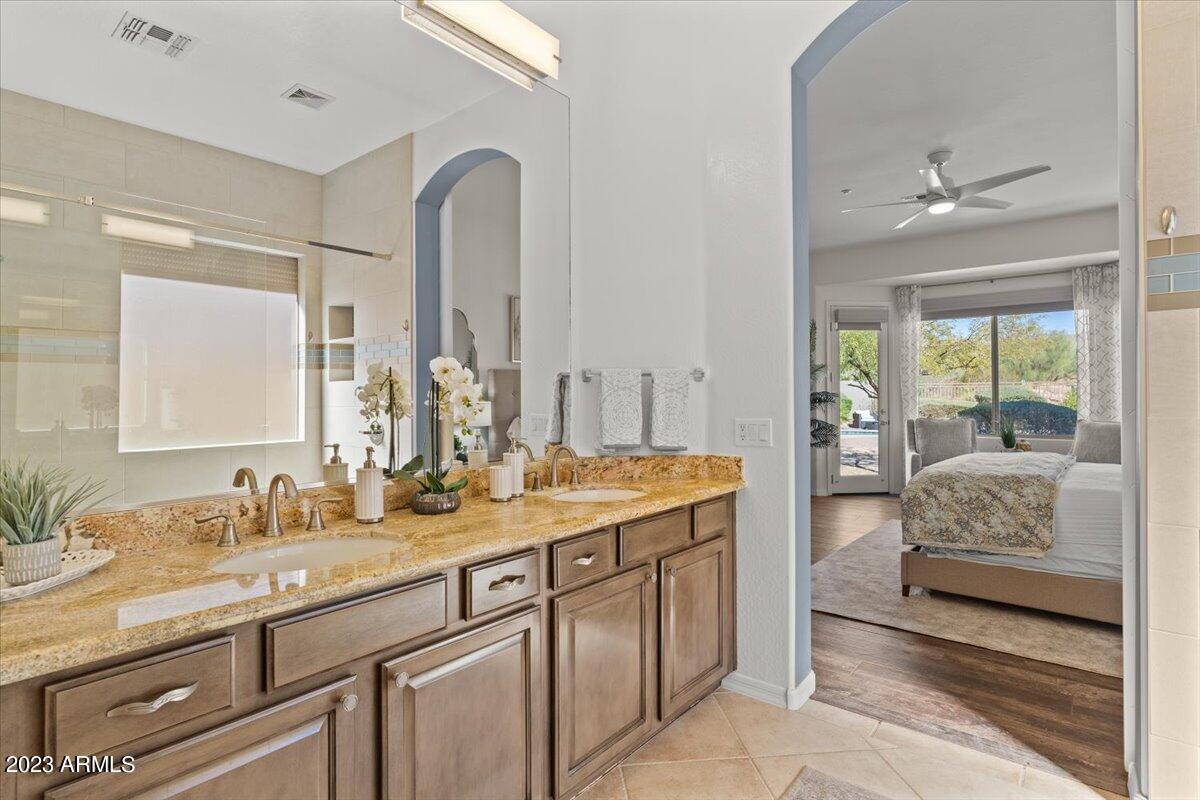 14257 North 106th Place Scottsdale, AZ 85255 - Photo 31 of 58 a en suite bathroom with sinks mirror and view bedroom