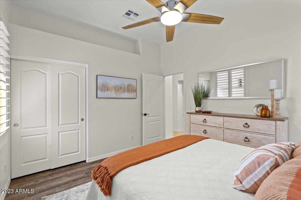 14257 North 106th Place Scottsdale, AZ 85255 - Photo 36 of 58 a bedroom with a bed and a chandelier