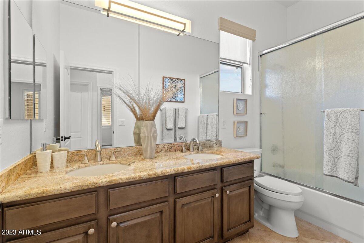 14257 North 106th Place Scottsdale, AZ 85255 - Photo 37 of 58 a bathroom with a granite countertop sink toilet and shower
