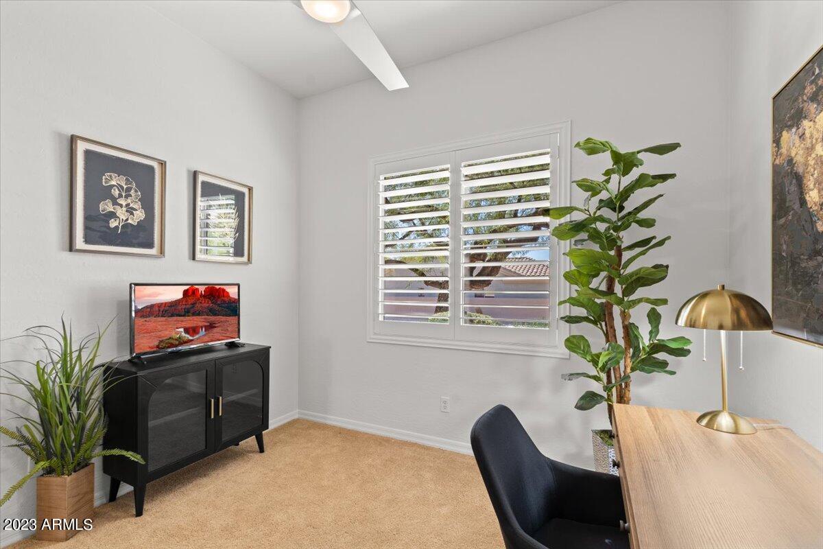14257 North 106th Place Scottsdale, AZ 85255 - Photo 40 of 58 a living room with furniture potted plant and a chair