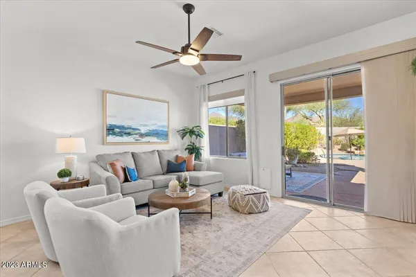 a kitchen with stainless steel appliances kitchen island granite countertop a refrigerator a stove a sink a dining table and chairs with wooden floor