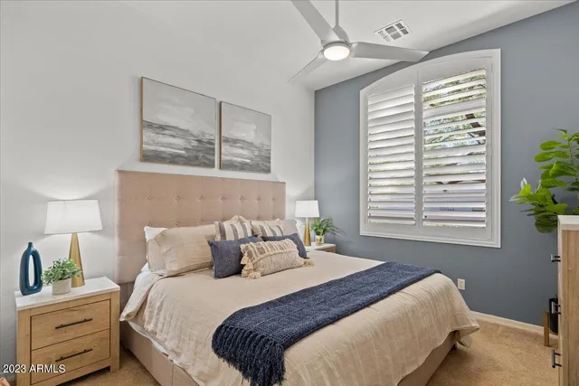 a view of a patio with a table and chairs under an umbrella