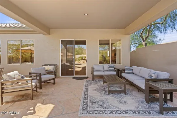a view of a house with backyard and sitting area