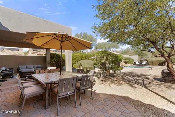 a view of a backyard with plants and a patio