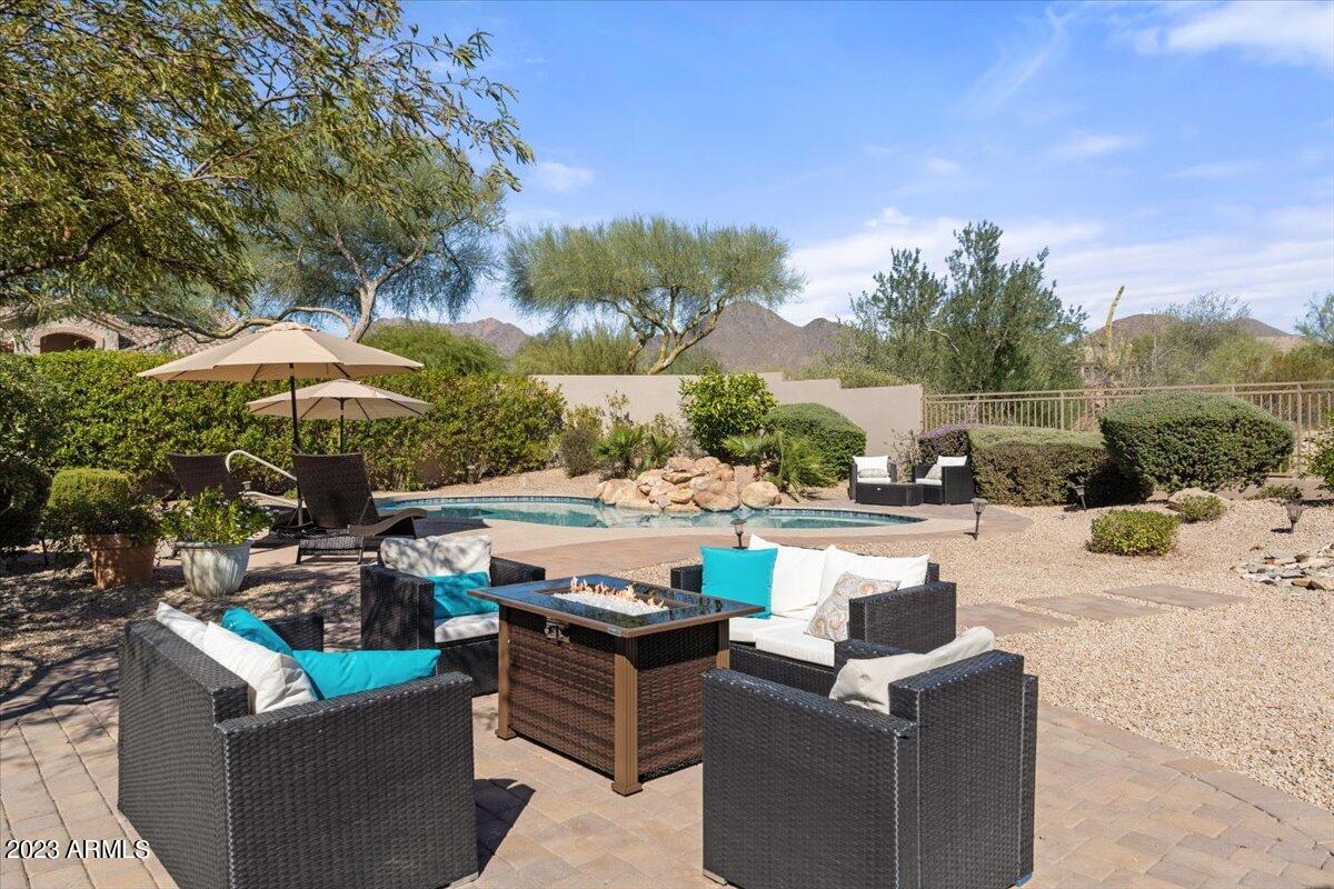 14257 North 106th Place Scottsdale, AZ 85255 - Photo 48 of 58 a view of a patio with couches and umbrella