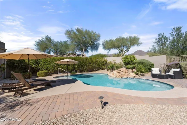 an aerial view of a house with yard swimming pool and lake view